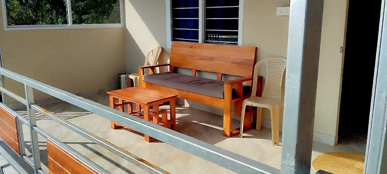 Relaxing on the wooden balcony seating at Green View Homestay