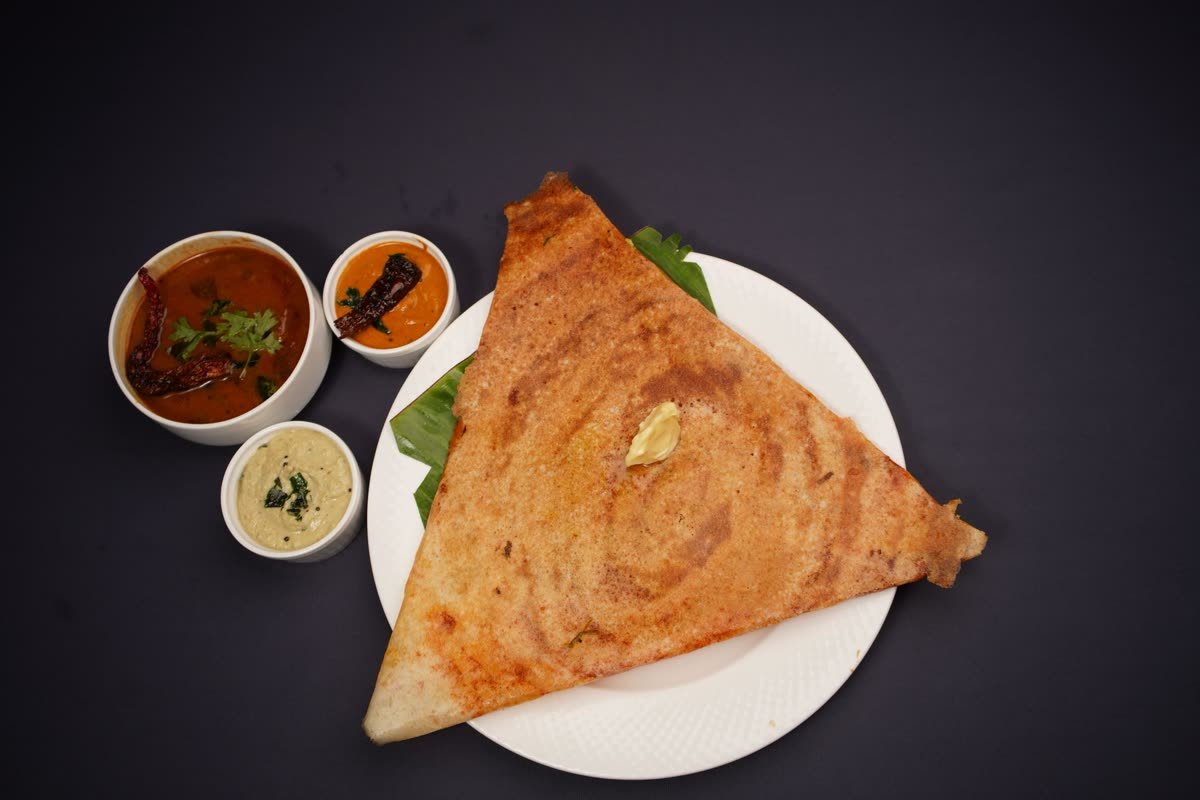 Crisp dosa served with sambar and chutneys