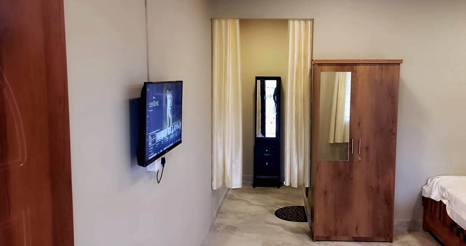 Room interior with television, wardrobe and mirror nook